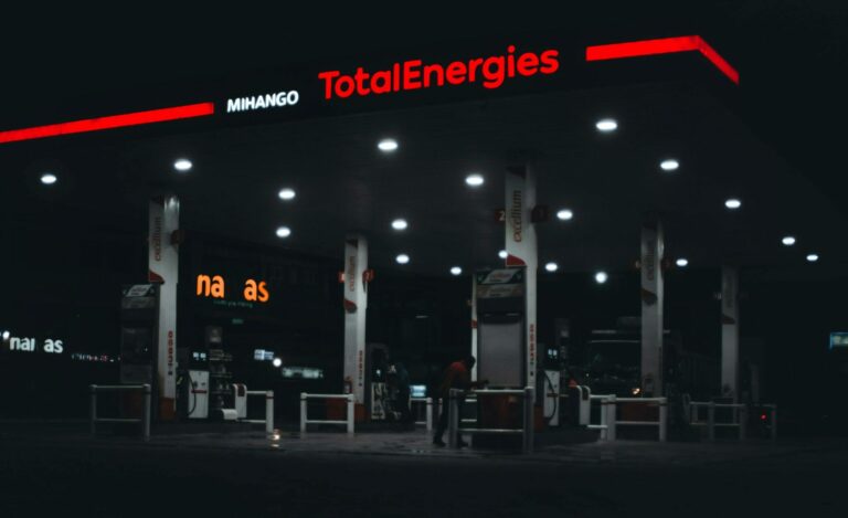 A dimly lit TotalEnergies gas station at night in Nairobi, Kenya, featuring prominent signage.